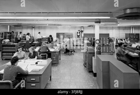 IBM 704 Computer Operations People on the photo are: Woman in the front with her back to the camera is Jean Ruddle Migneault. She provided the names for the rest of the staff in the photo. Kathy Christian Young, Mary Talmage Kaylor, Willie Terrell Ruffin (computer operator not mathematician), J Stock Photo