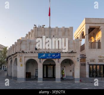 Traditional Qatari style police station building with national flag flying above in historic Souq Waqif market, Doha, Qatar. Stock Photo