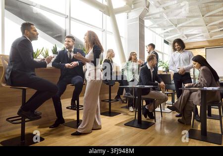 Business team networking on coffee break, colleagues talking in modern office Stock Photo