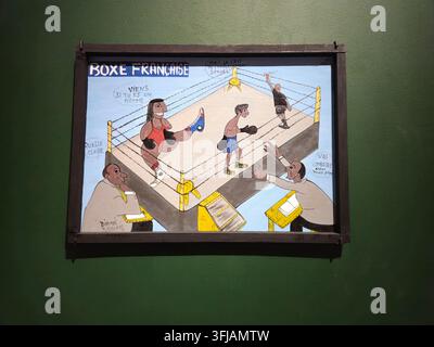 Stockholm, Sweden, January 11, 2026. Framed folk art painting titled Boxe Francaise showing cartoon boxers in a ring with spectators and referee, disp Stock Photo