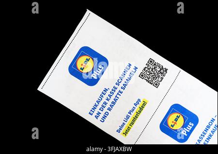 Iserlohn, Germany - September 16, 2026: Lidl Plus loyalty program logo and QR code printed on a supermarket paper receipt. Stock Photo