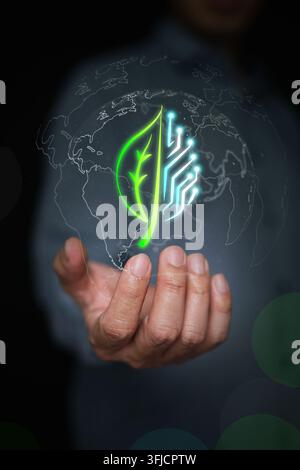 Hand holds hybrid leaf and digital circuit board inside earth globe outline. Green technology, sustainable innovation, global ESG initiatives, and eco Stock Photo