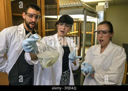 Lawrence, Kansas - January 16, 2016: Three chemistry research students are very surprised and shocked by the results in their test tube experiment. Ed Stock Photo