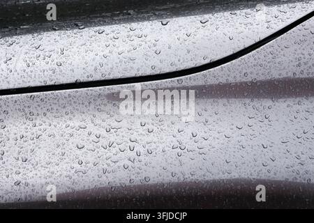 Reflection Image Bright A rain droplet on reflective vehicle roof and window surface after ...