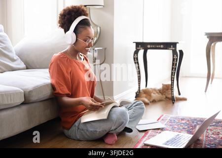 Young 25s African woman studying at home Stock Photo