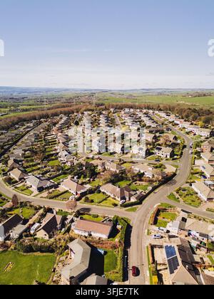 An aerial view captures village homes nestled between mountains and ...