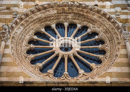 Close up view of a medieval rose window with historic stone carvings and patterns Stock Photo