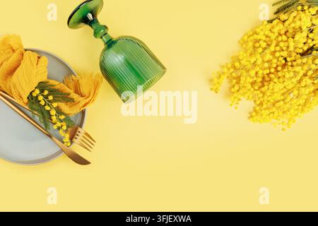 Spring festive table with mimosa and copy space for holiday greeting design Stock Photo