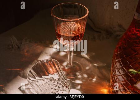 Rose Sparkling Wine Bottle and Crystal Glass in Cozy Restaurant Light Stock Photo