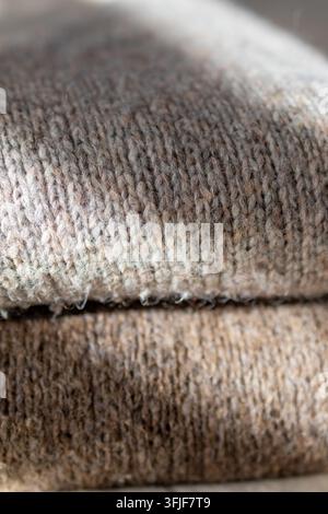 Close up texture of soft knitted sweater shows cozy wool alpaca and mohair fabric detail. Concept of warm autumn knitwear texture and cozy wardrobe fa Stock Photo