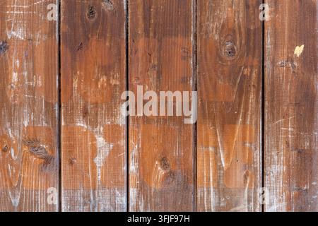 Weathered brown wooden planks form a rustic textured background. Stock Photo