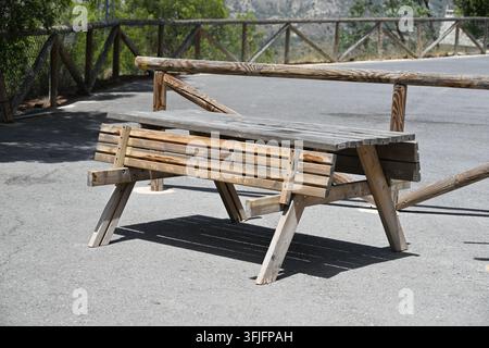 Weathered Wooden Table with Folding Benches for Guests Stock Photo