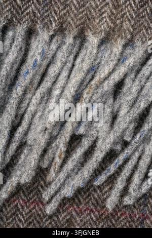 Abstract close-up showing dense gray textile fibers arranged in raised parallel ridges, with subtle blue and reddish threads visible in the textured m Stock Photo