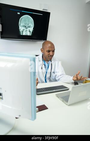 Doctor feeling frustration while analyzing a patient's skull x-ray in a modern medical office Stock Photo