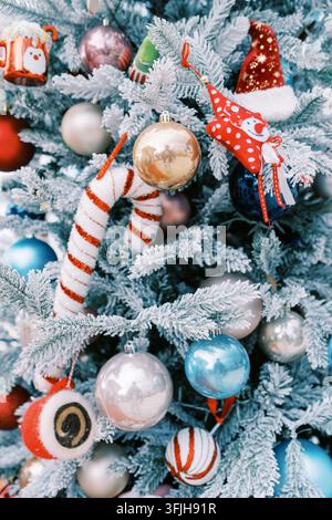 Frosted Christmas Tree with Colorful Ornaments and Decorations Stock Photo