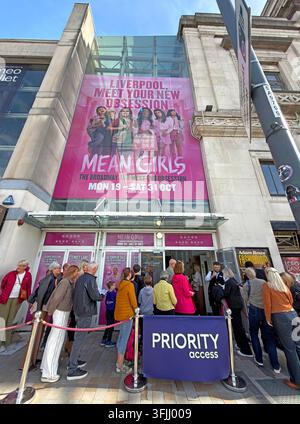 Priority access queue at Liverpool Empire Theatre on Lime Street for the musical Mean Girls, showing theatre-goers outside the venue. Stock Photo