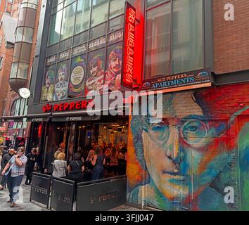 Sgt Peppers bar and rooms, live music venue on Mathew Street, Liverpool, with a large John Lennon mural in the Cavern Quarter,tourists 1960s Stock Photo