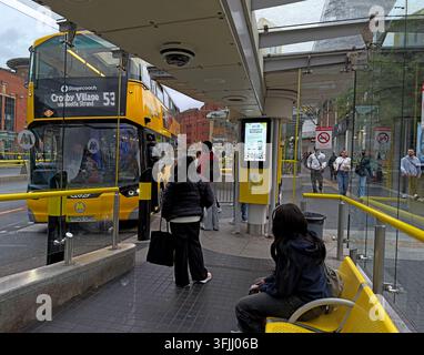 Passenger boarding a Liverpool City Region EV Wrightbus Electroliner Metro electric bus at Queen Square during the 2026 rollout of franchised services Stock Photo