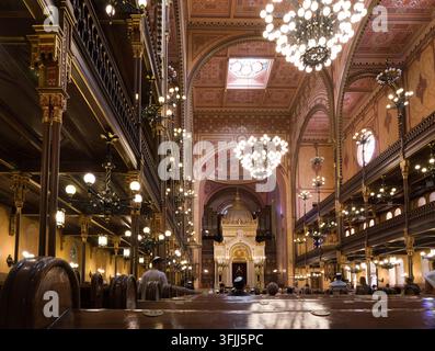 Worshippers gather to pray during a service inside the ornate Great Synagogue on Dohány Street in Budapest, Hungary. Stock Photo