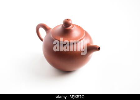 Close up of traditional brown clay teapot isolated on white background with copy space Stock Photo
