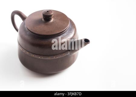 Close up of traditional brown clay teapot isolated on white background with copy space Stock Photo