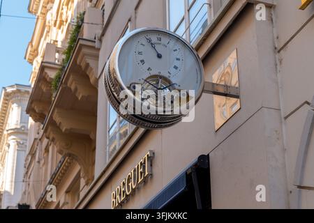 Vienna, Austria, 12 September 2026, A Breguet branded clock hangs on an elegant building facade along a city street. Stock Photo