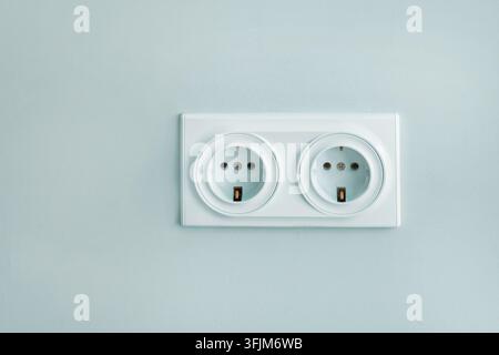 European standard double electrical outlet on light blue wall Stock Photo