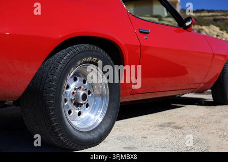 Low angle, side view of the red, american muscle car Stock Photo