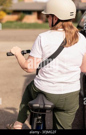 Over the shoulder view of a woman on an e bike Stock Photo