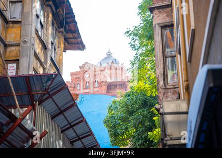 Istanbul, Turkey - August 28, 2026: Virgin Mary Greek Orthodox Church between narrow alleyway in urban setting surrounded by greenery and older Stock Photo