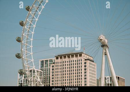 London, England, United Kingdom, August 14, 2026. Close perspective showing the hub, spokes, and glass pods of the London Eye with the Shell Centre bu Stock Photo