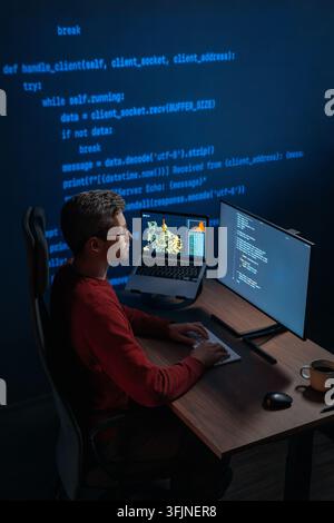 Data scientist works at night on artificial intelligence project, types on keyboard, screens displaying scripts and graphs, projection with running code on a wall behind. Copy space Stock Photo