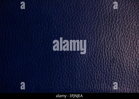 Dark blue leather texture with subtle grainy glitter shimmer, sophisticated surface pattern perfect for luxury backgrounds Stock Photo