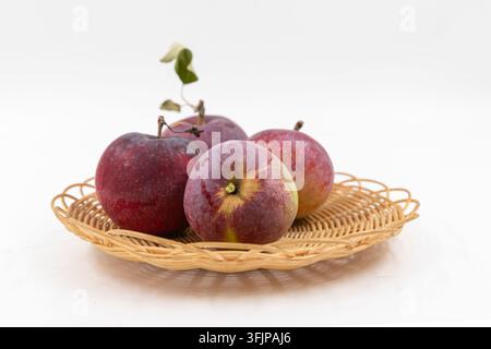 Four Red and Yellow Apples with Stems and Leaves on White Stock Photo