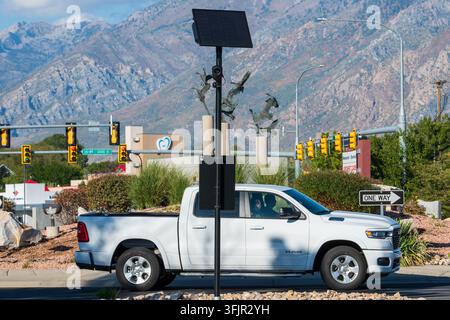American Fork, Utah, USA. 20th Sep, 2026. A wide view shows a solar-powered Flock Safety automated license plate reader (ALPR) public safety surveillance camera monitoring vehicle traffic passing through a traffic roundabout intersection. The system tracks vehicular movements to assist law enforcement and private security with public safety and automated data collection. (Credit Image: © Charles McClintock Wilson/ZUMA Press Wire) EDITORIAL USAGE ONLY! Not for Commercial USAGE! Stock Photo
