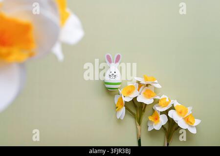Easter bunny and spring daffodils Stock Photo