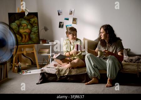 Couple Drinking Coffee and Relaxing at Home in Morning Stock Photo
