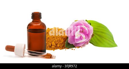 Turmeric powder with fresh turmeric flower, dropper and bottle containing turmeric extract, isolated on white background, representing natural herbal Stock Photo