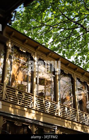 Traditional wooden facade with carved balcony details in historic district of Tbilisi Georgia Stock Photo