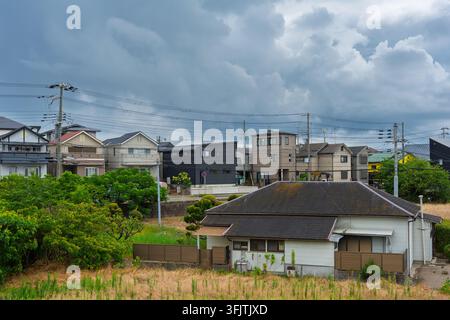 Storm clouds gather over suburban houses in quiet residential area Stock Photo