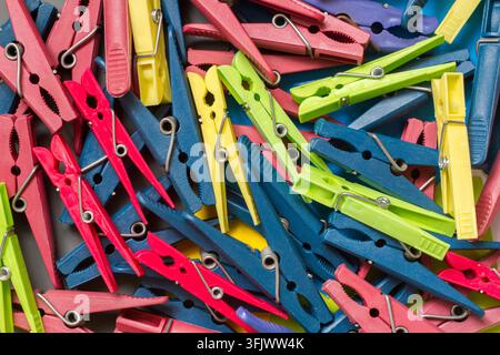 Lots of colorful plastic clothespins. The texture of clothespins. Stock Photo