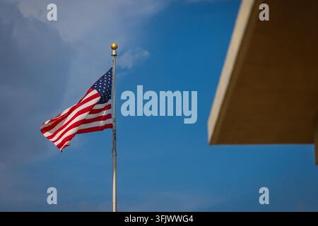 The United States of America flag waving in the wind on a sunny day. Stock Photo