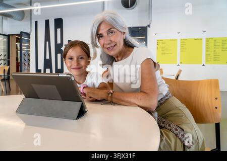 Grandmother and granddaughter bonding, learning together using digital tablet Stock Photo
