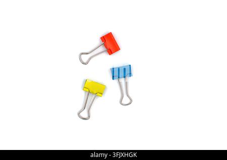Three colorful metal binder clips isolated on white background Stock Photo