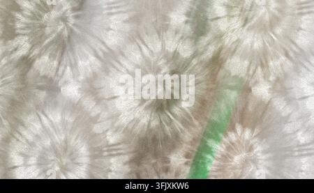 Muted tie-dye pattern on neutral beige and white fabric with subtle starburst motifs and grainy texture. Stock Photo