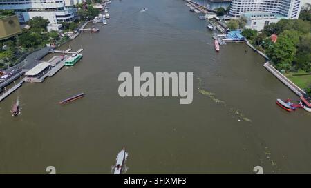 BANGKOK, THAILAND - MAR 15, 2026: High angle view of passenger boats and ferries navigating the Chao Phraya River in Bangkok, Thailand. Stock Photo