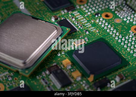 A close view reveals a computer circuit board with various chips and connectors. The image shows details of electronic components and soldering. Stock Photo
