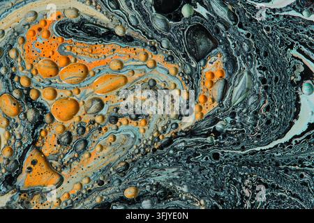 Dynamic abstract fluid art background featuring bright orange patches and dark swirls Stock Photo