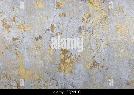 Abstract distressed wall texture with weathered gold leaf Stock Photo