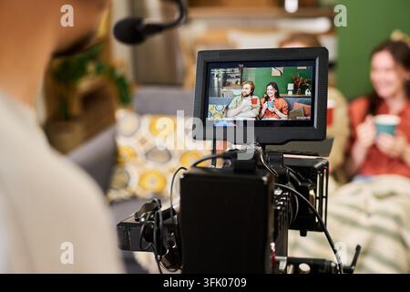 Camera Operator Filming Man and Woman for Video Production Stock Photo